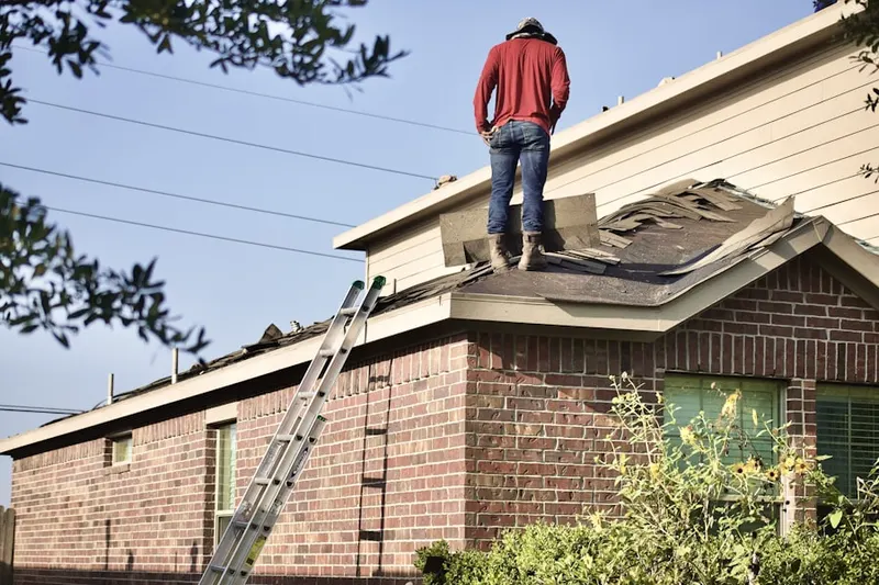Professional roofer working on a residential roof in Starcrest